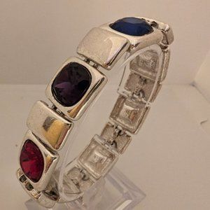 Silver bracelet with colored gems.  Magnetic closure